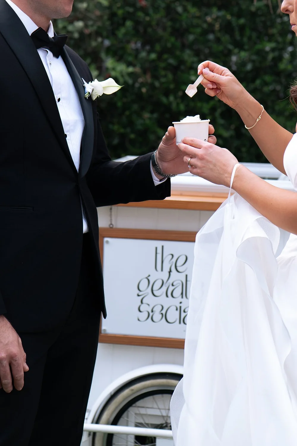 Bride feeding the groom a spoonful of gelato