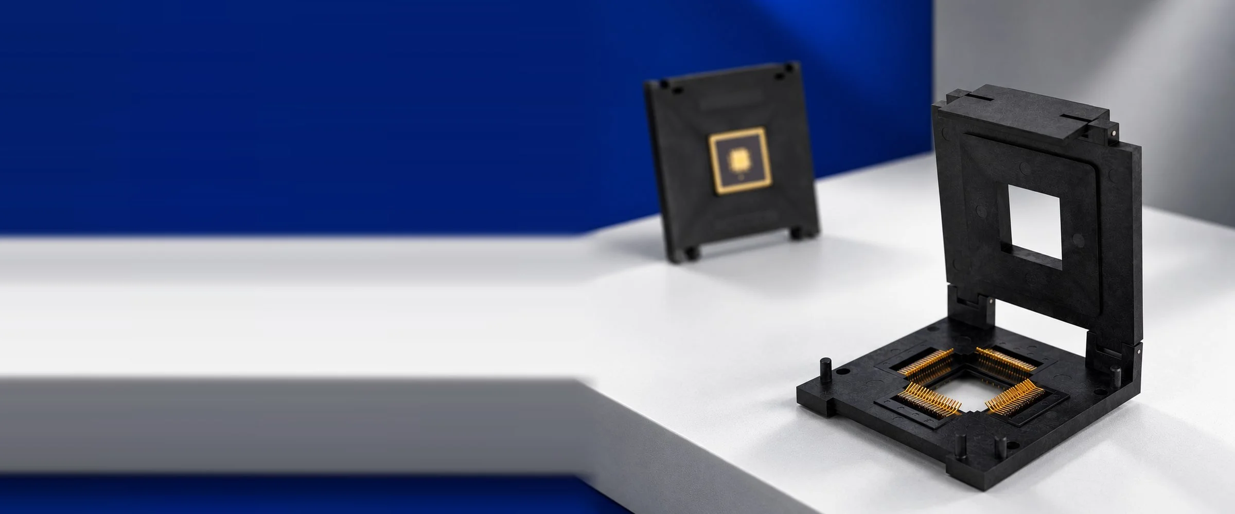 Azimuth Electronics IC socket with open window lid and gold contacts, with a matching socket lid in the background