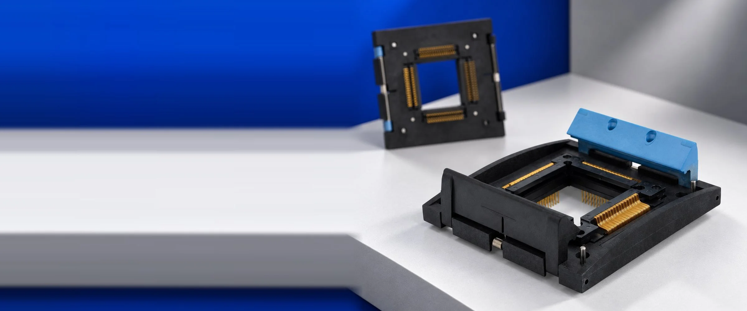 Azimuth Electronics IC socket with blue latch lid and gold contacts, with the socket underside shown in the background