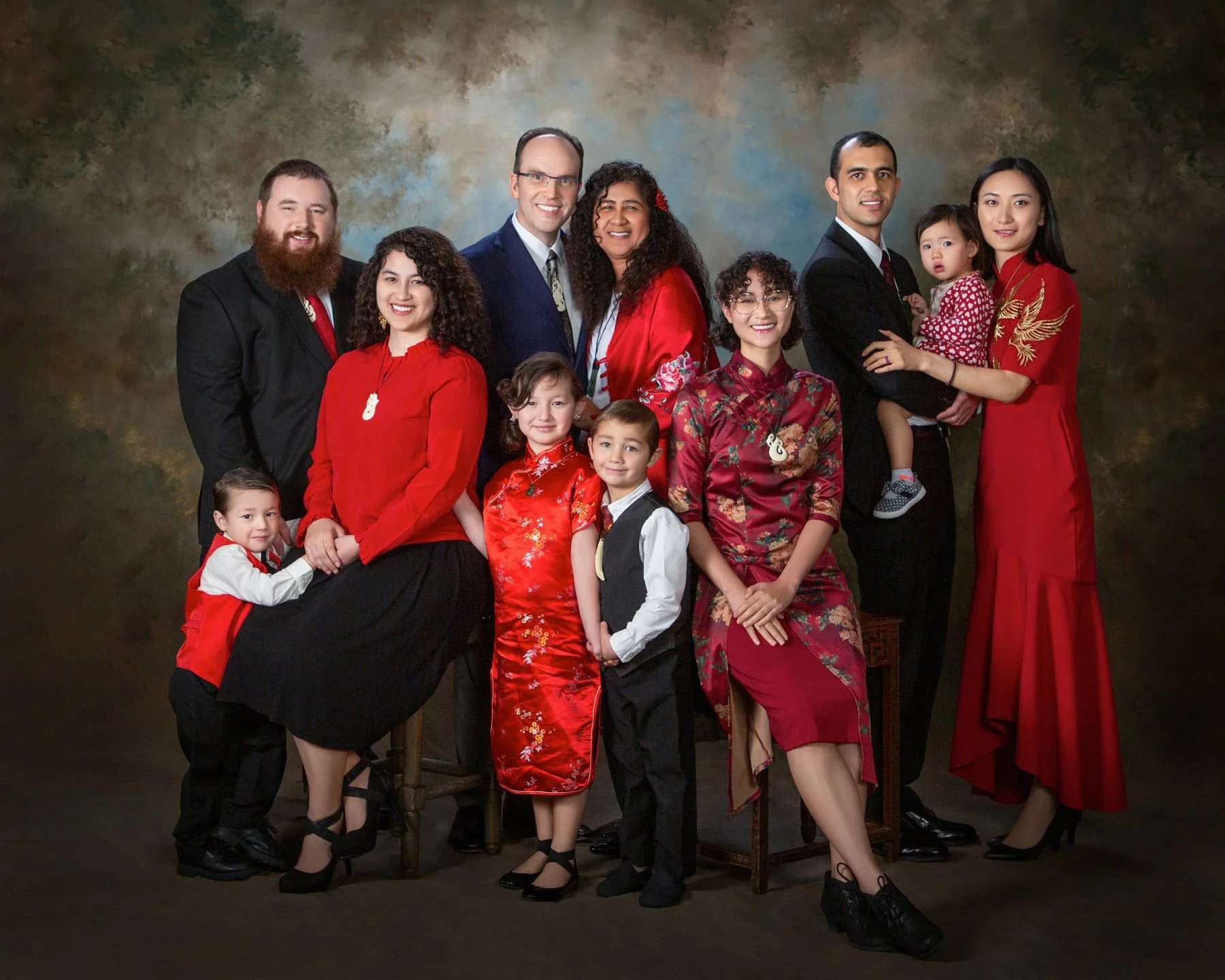 A large multi-generational family in red and black formal dress
