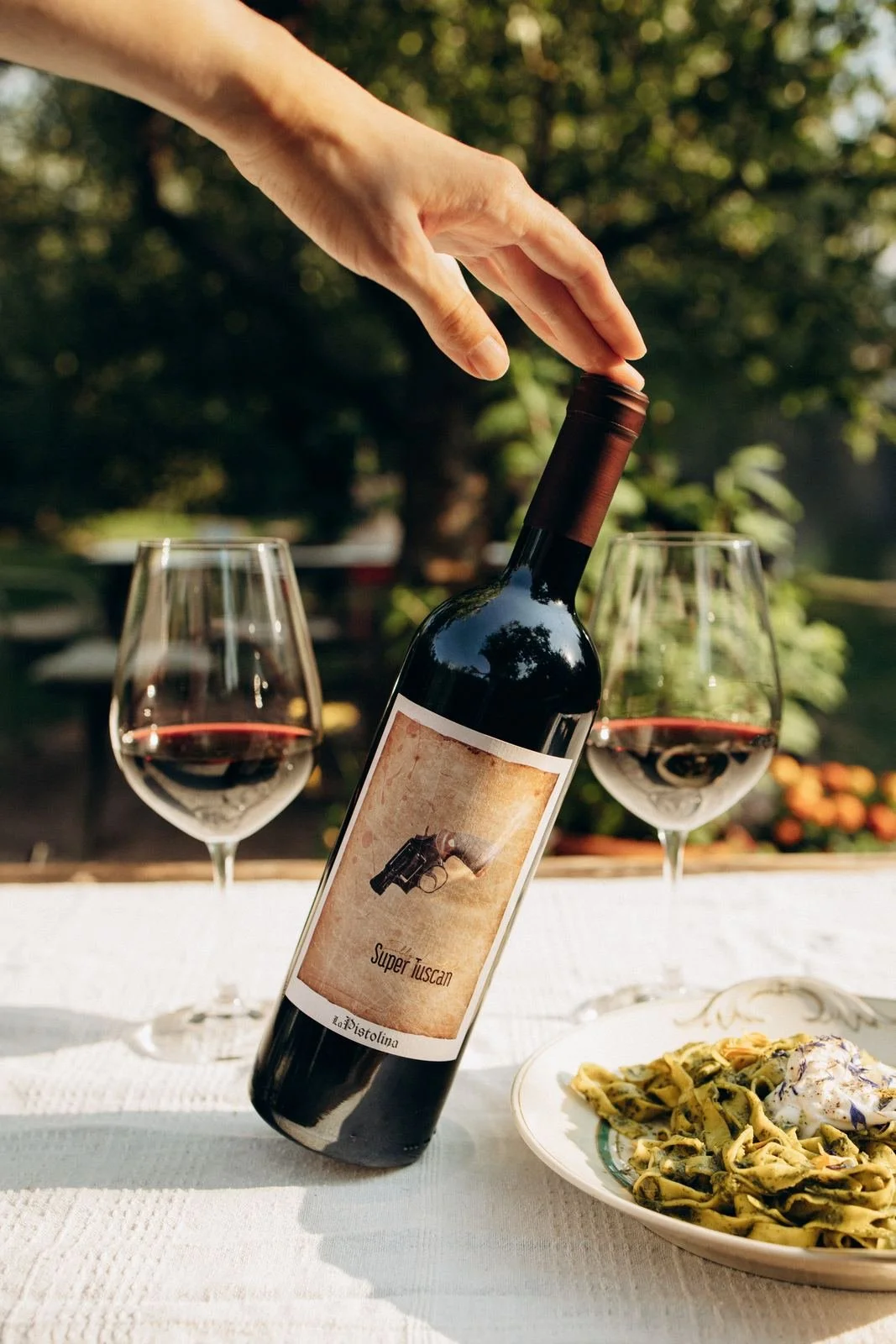 La Pistolina Super Tuscan being lifted from a sunlit table