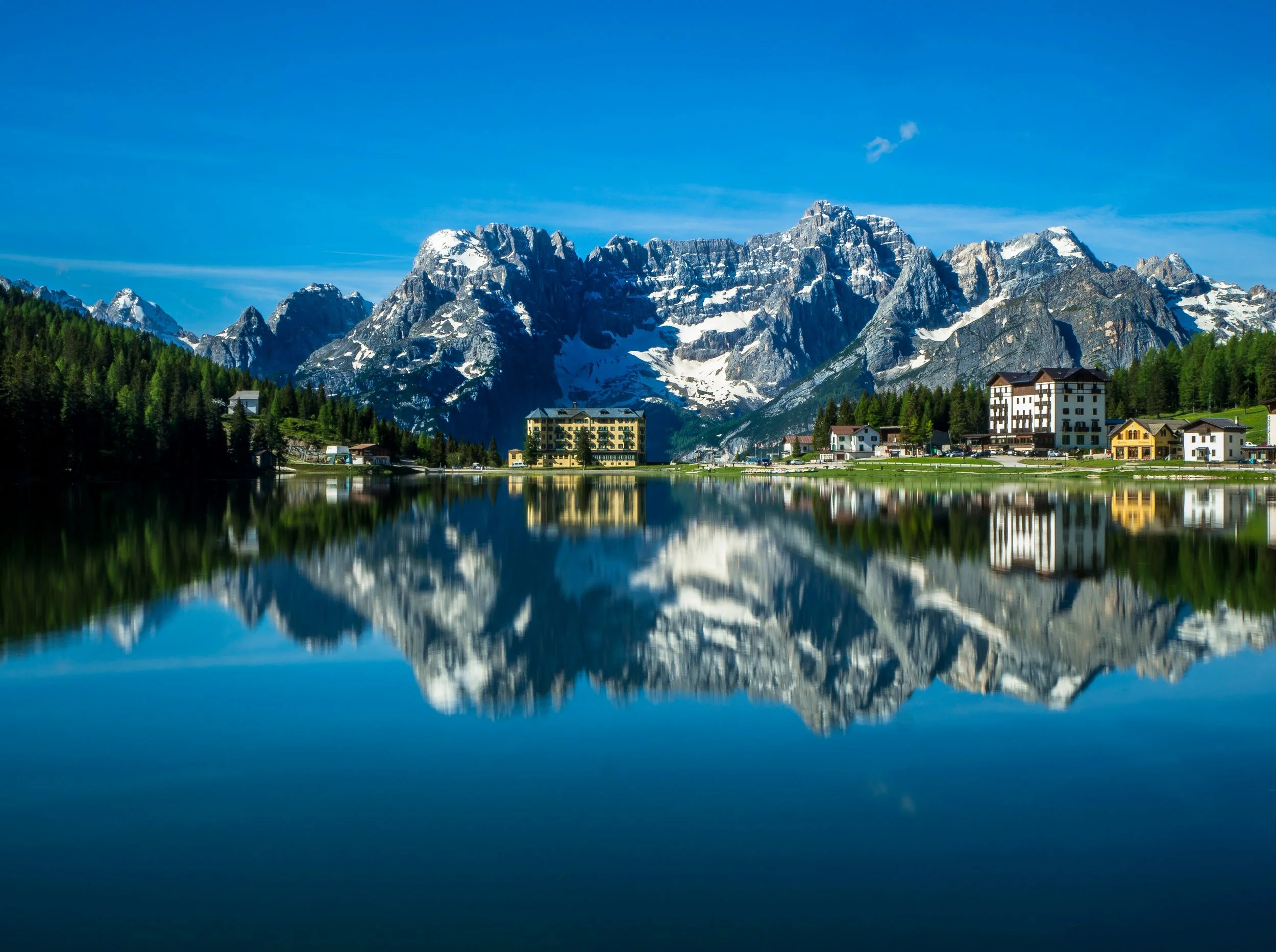 Trail running near Lake Misurina in the Dolomites with mountain reflections