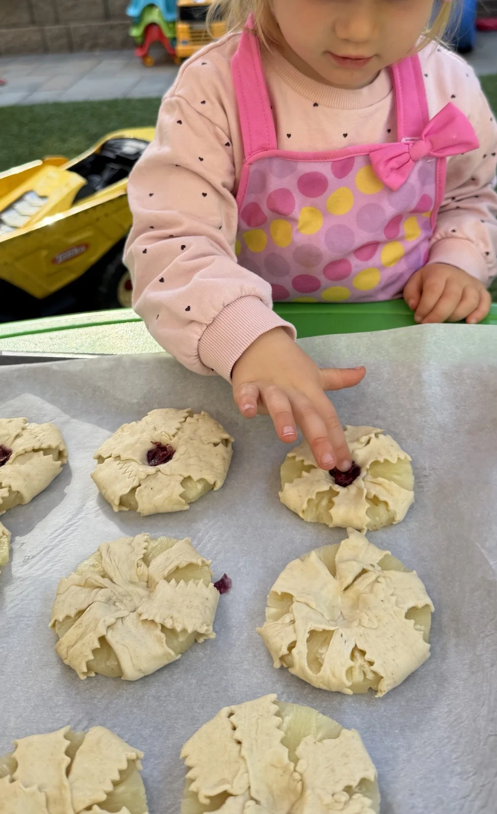 A child helping decorate homemade dough at Mila-Ma