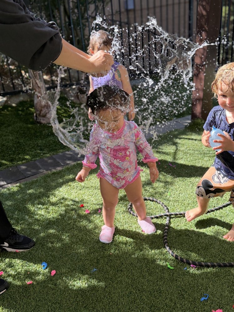 Children enjoying spraying water outdoors