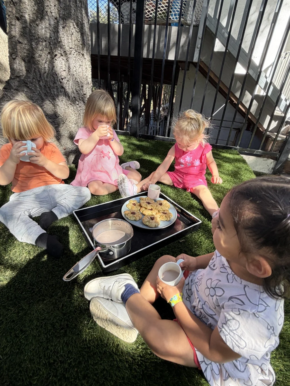 Children gathered for food and conversation outdoors