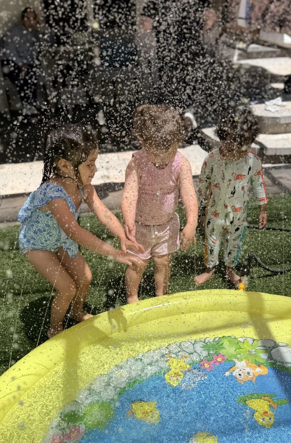 Children enjoying splashing water during outdoor play