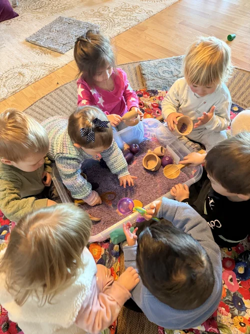 Children gathering around a shared outdoor activity