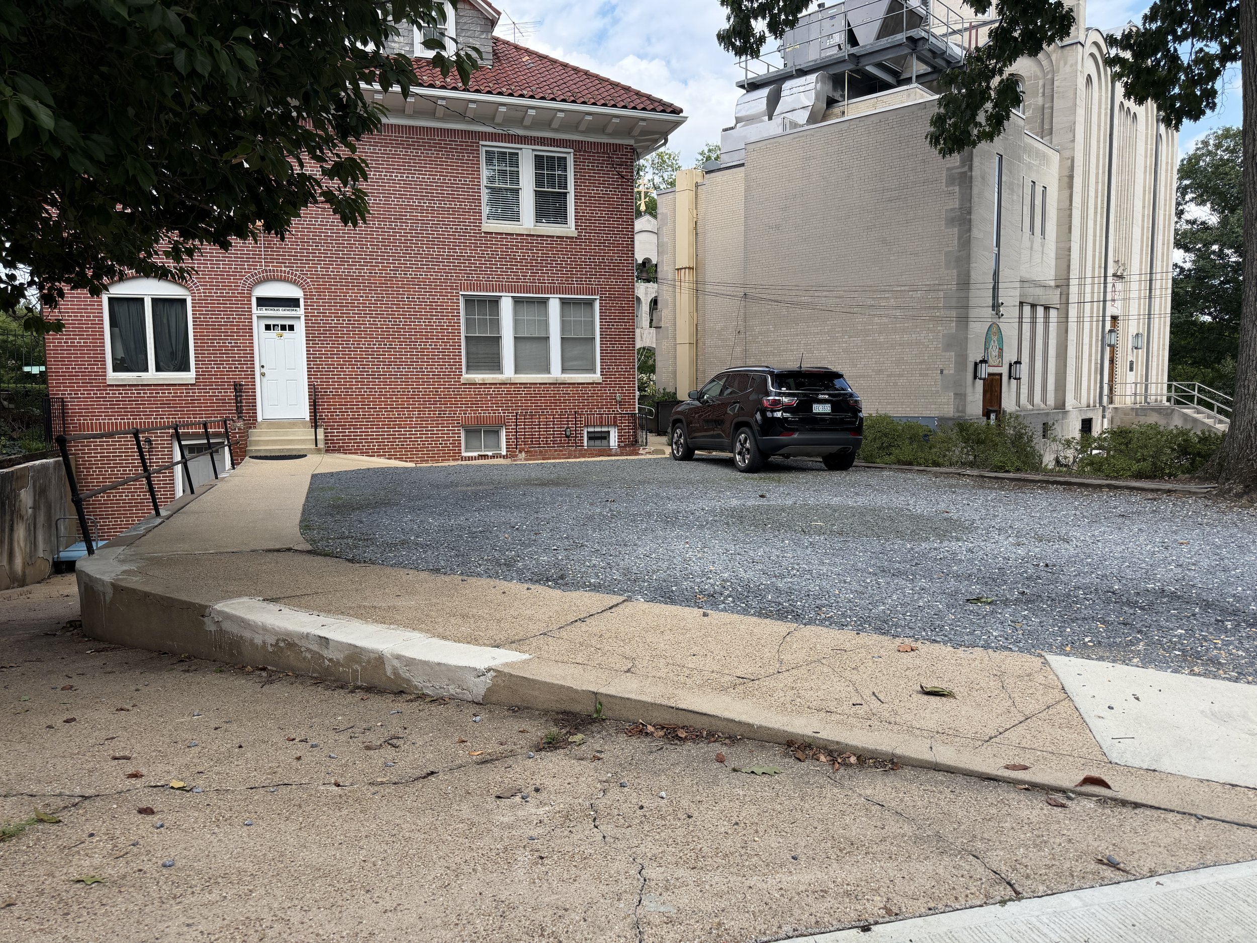 The gravel parking area between the Cathedral and annex