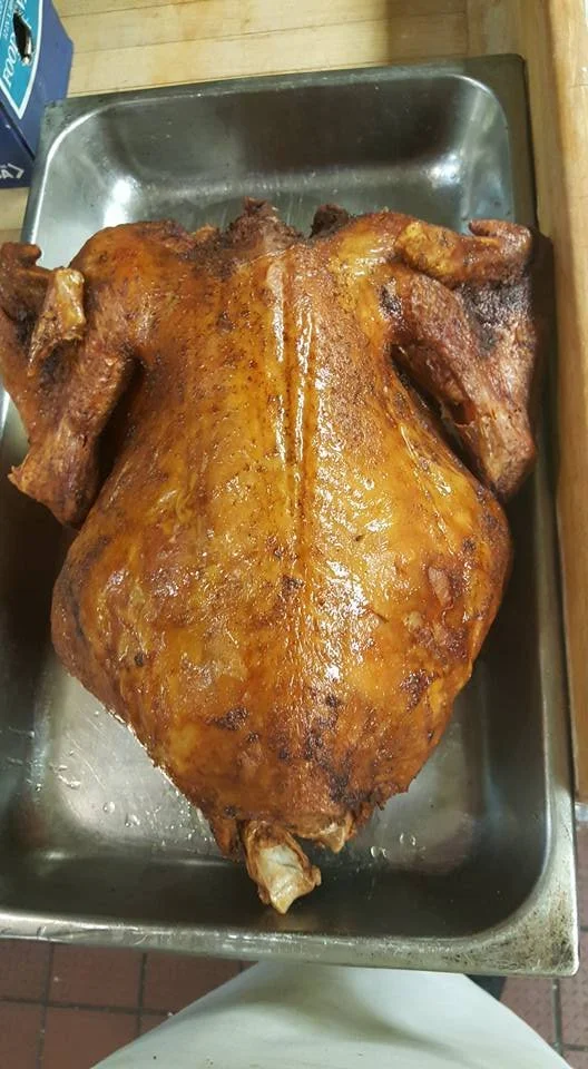Niecie’s golden deep-fried whole turkey resting in a metal roasting pan