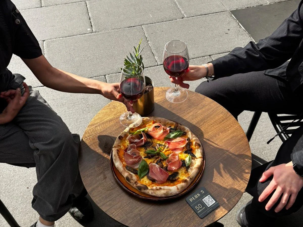 Pizza and wine on the riverside terrace at Plus 5 Bar in South Wharf