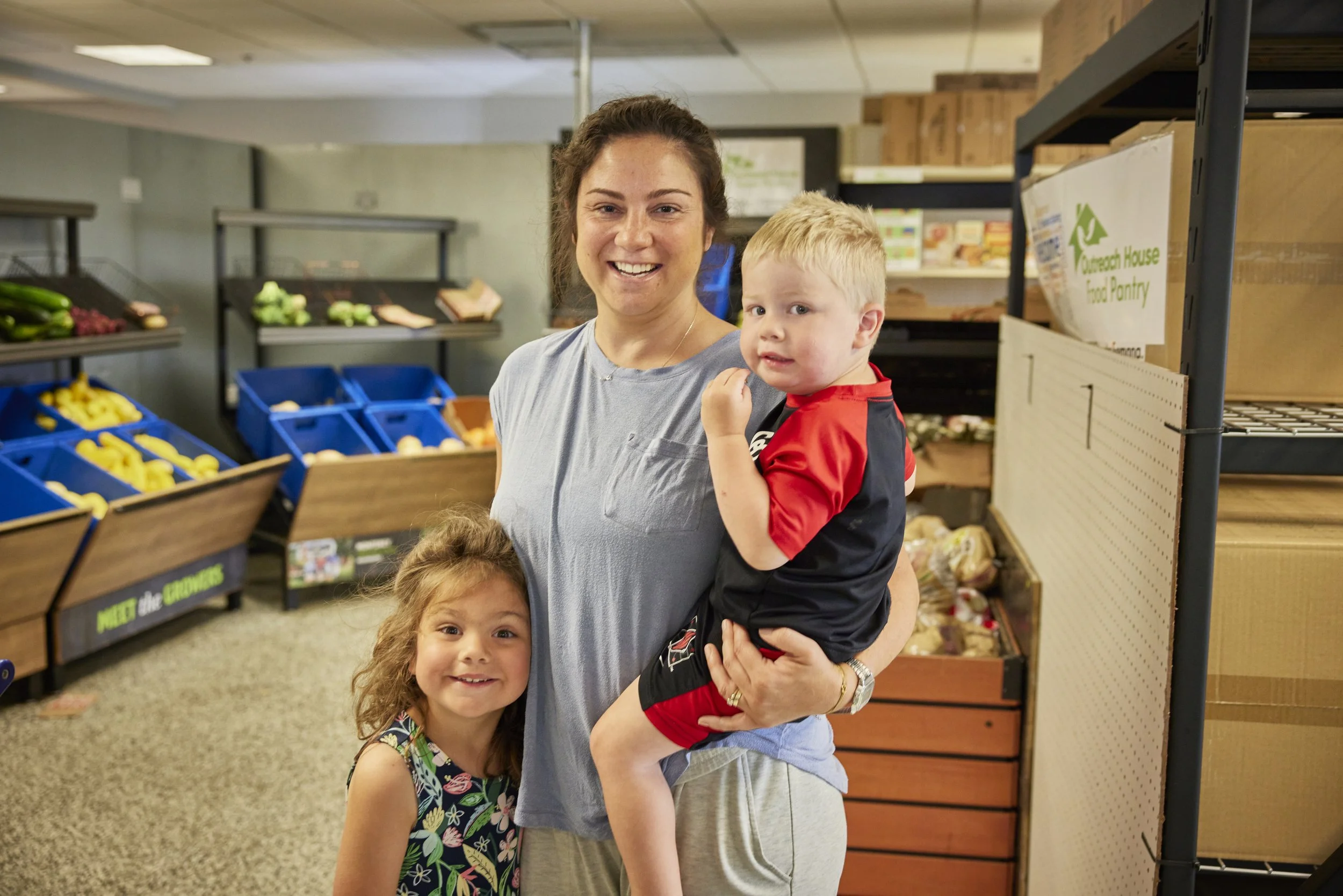 A family shopping in The Outreach House food pantry