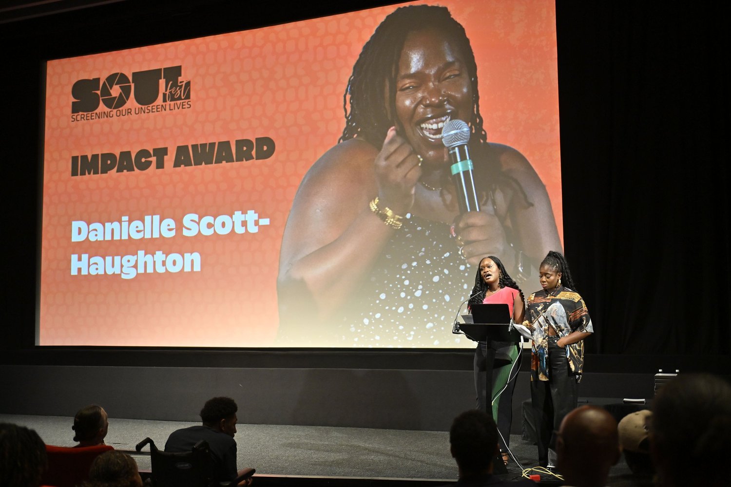 Clara Amfo and Bolu Babalola on stage at BFI Southbank, with Danielle Scott-Haughton on the screen behind them