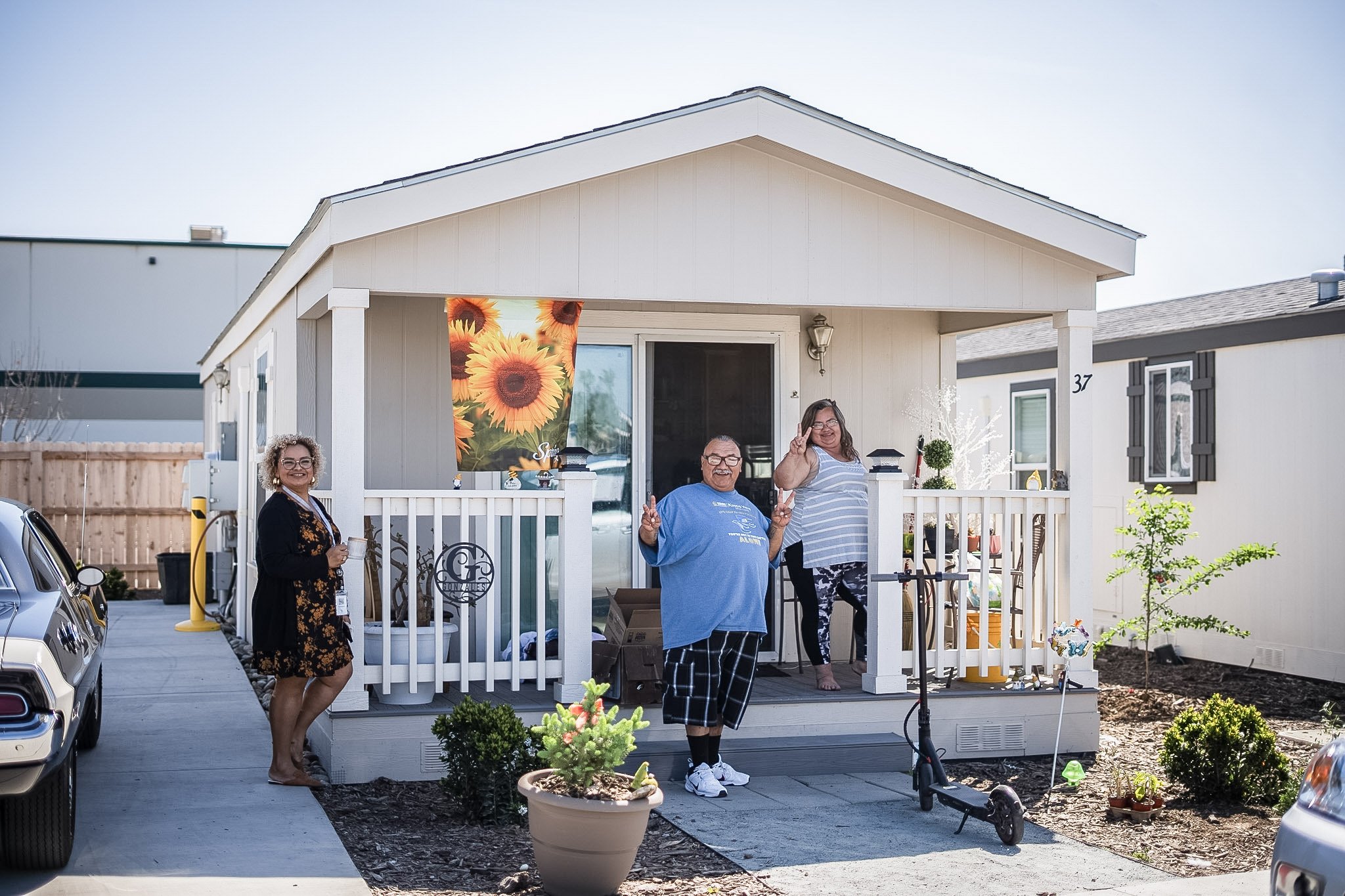 photo of neighbors posing in front of house