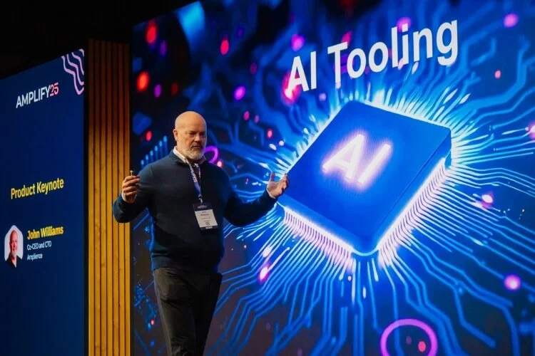 Amplify25 event photography showing a presentation on AI tooling on stage.