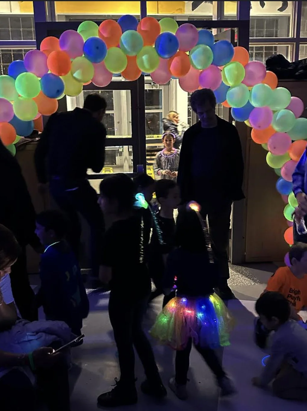 20-foot neon confetti style balloon arch in Manhattan NYC for glow party — daylight view