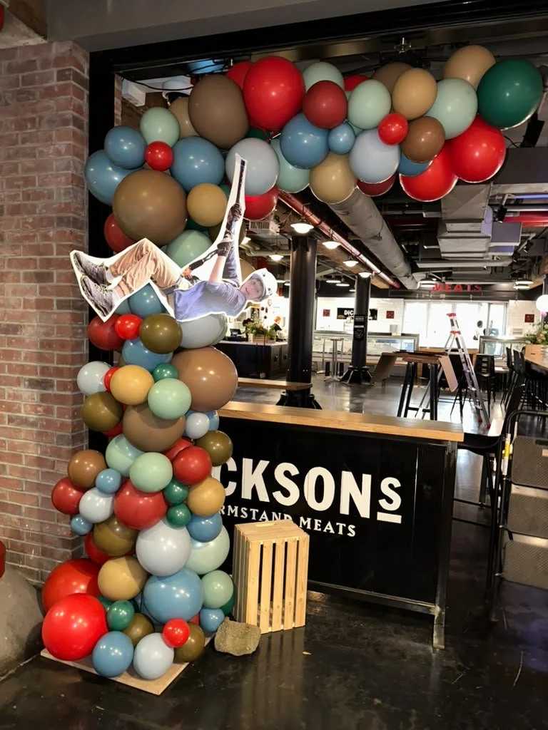Organic balloon column and ceiling arch at Dixon's Farmstand Meats Chelsea Market NYC Bar Mitzvah