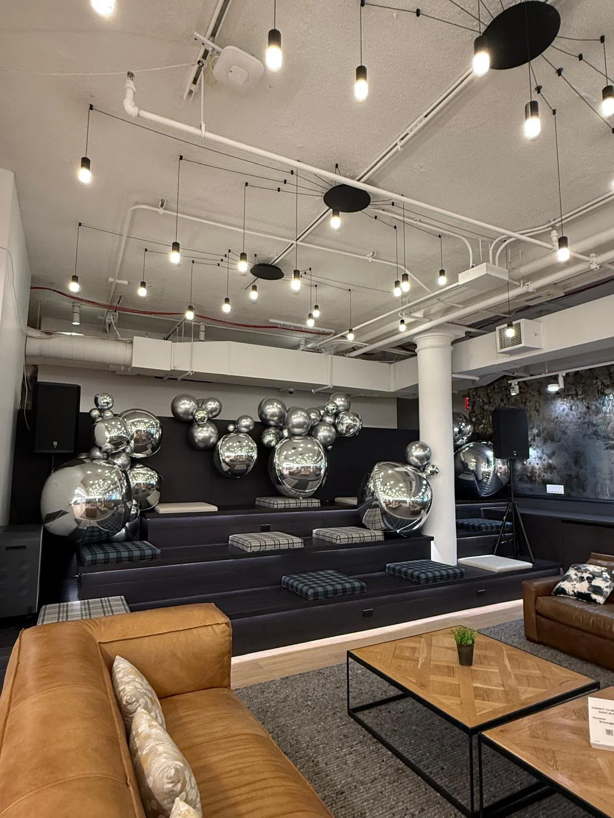 Silver balloon wall behind lounge bleacher seating at Nielsen's Media Intelligence Lab kickoff Chelsea NYC