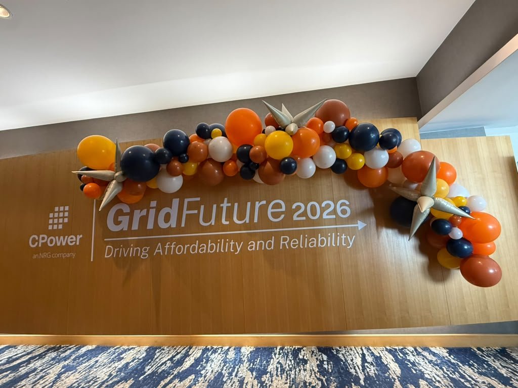 Branded balloon garland above the CPower GridFuture 2026 wall sign at the Hyatt Jersey City NJ