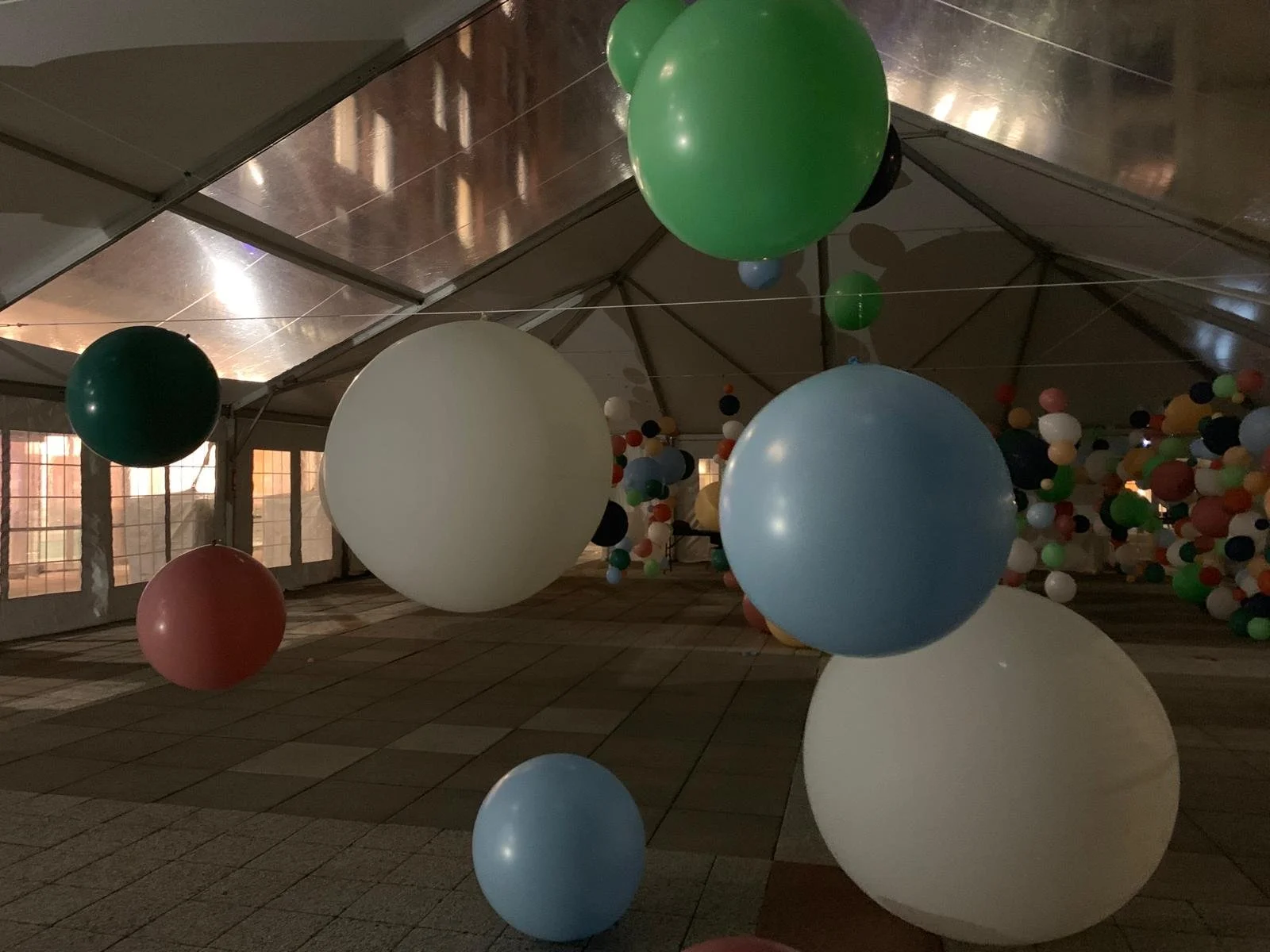 Large suspended balloon orbs at eye level in an experiential installation at NYU Greenwich Village NYC