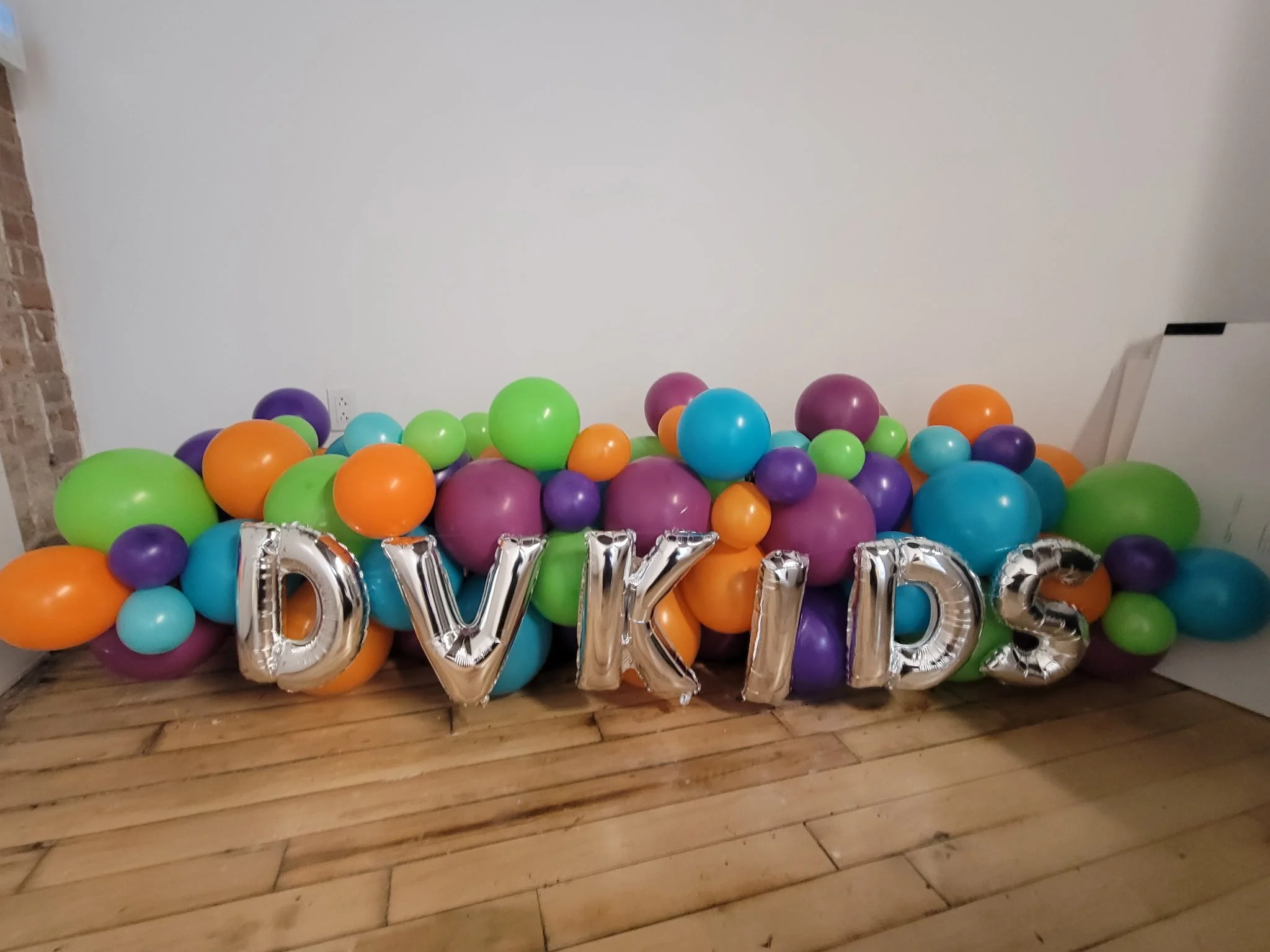 Classic style balloon marquee spelling DV KIDS with silver foil letters for DoubleVerify SoHo NYC office event