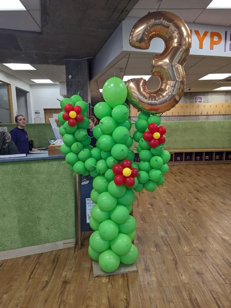 Handmade balloon cactus sculpture with gold number 3