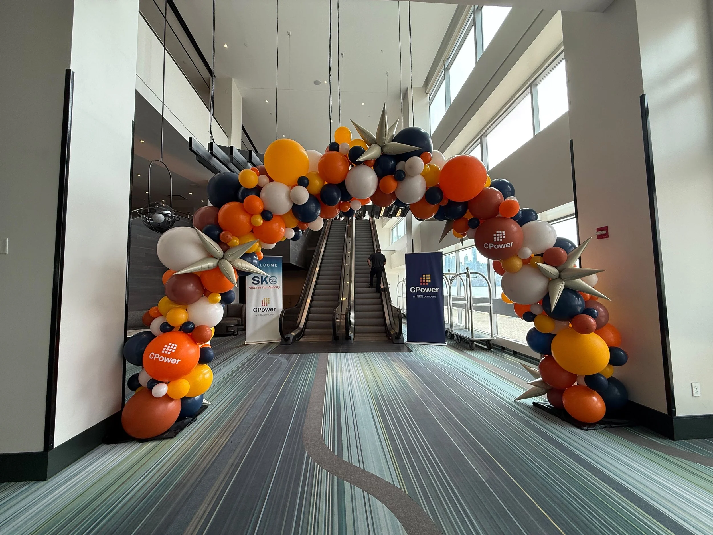 25-foot organic balloon arch with custom CPower branding at the Hyatt Regency Jersey City NJ corporate event