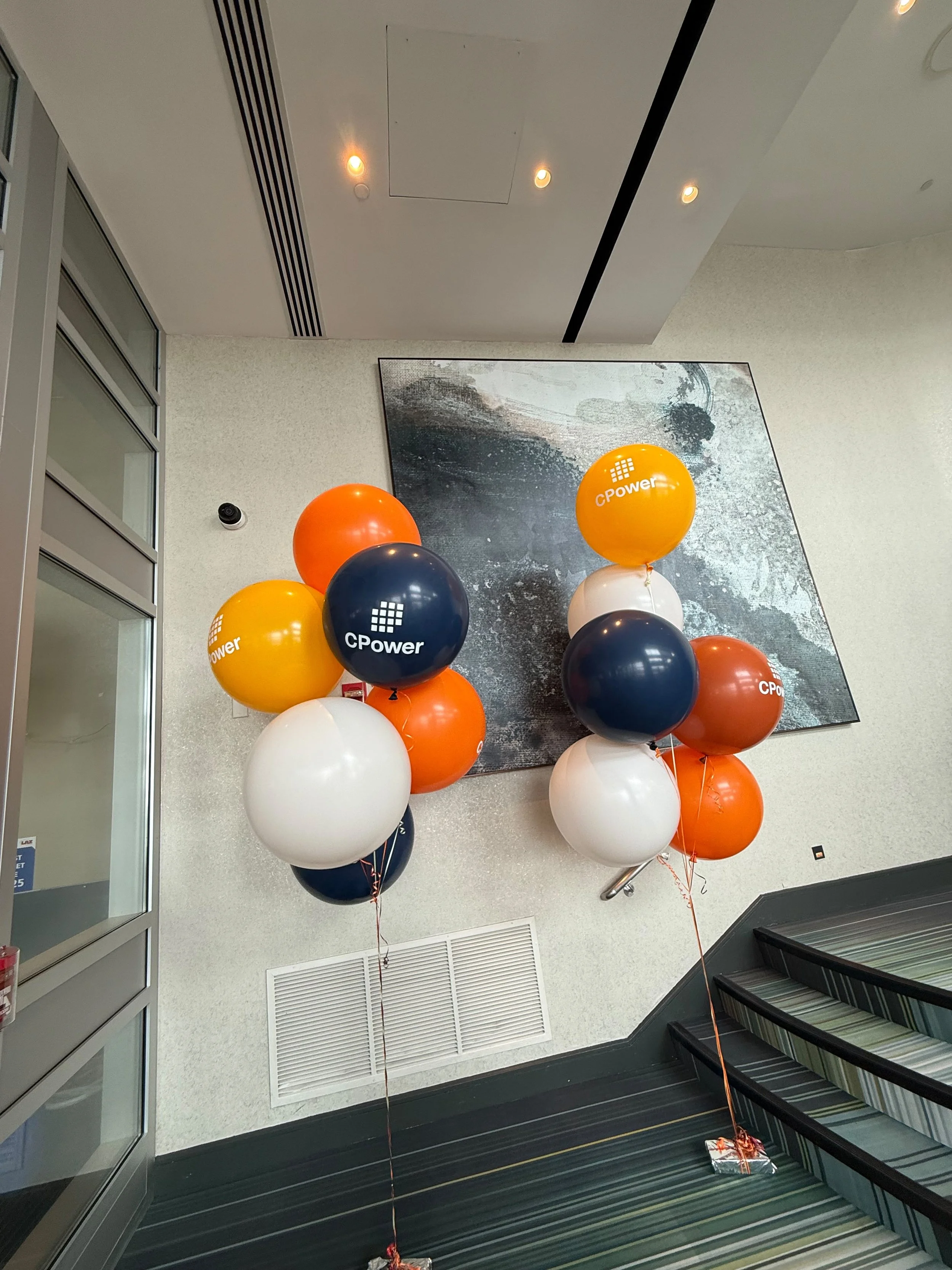 Custom CPower branded helium balloon clusters at a corporate event Hyatt Jersey City NJ
