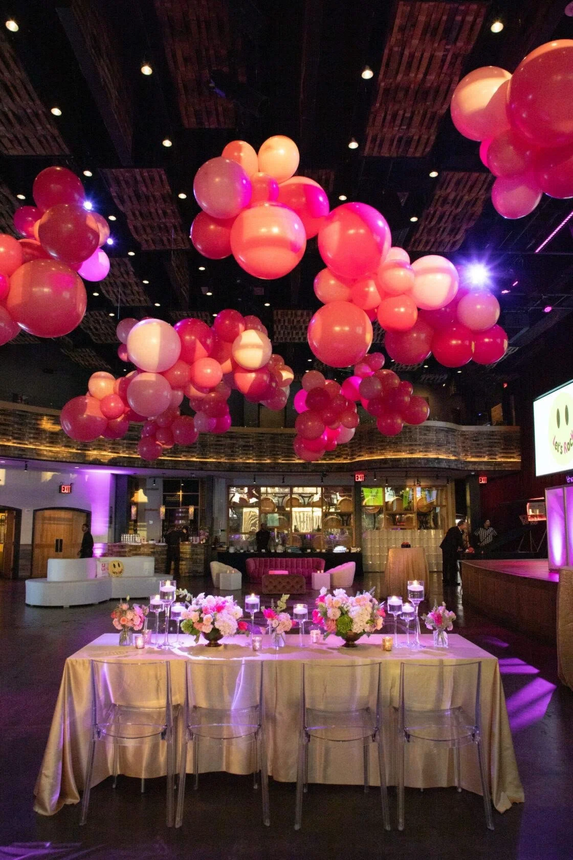 Bat mitzvah balloon clouds above a florals and candlelit table at City Winery Chelsea Manhattan NYC
