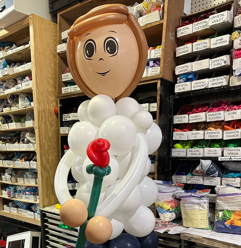Custom balloon promposal sculpture of a boy holding a red rose — Manhattan balloon decor by Blossom Flower Amanda, NYC