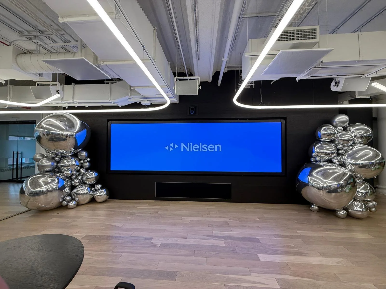 Silver balloon towers flanking a screen at Nielsen's Media Intelligence Lab kickoff in Chelsea NYC