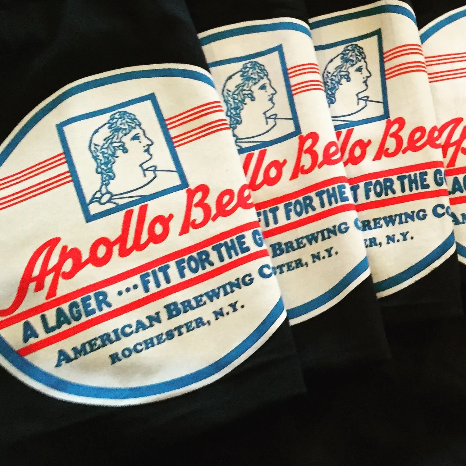 Navy Apollo Beer tees fanned out