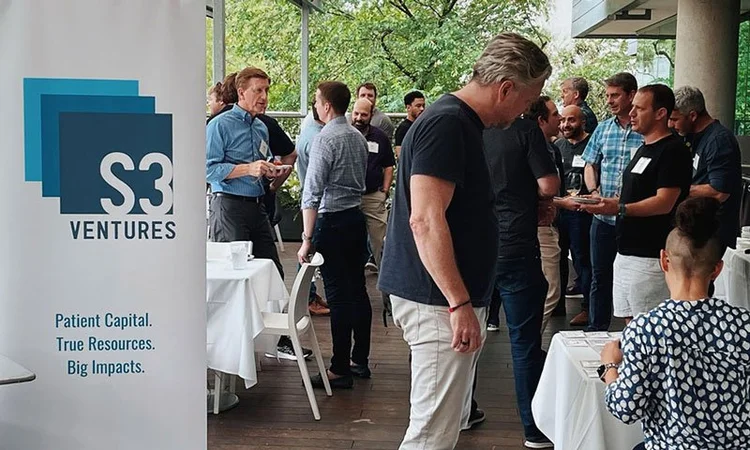 S3 Ventures sign with a group of people behind it in the background. 