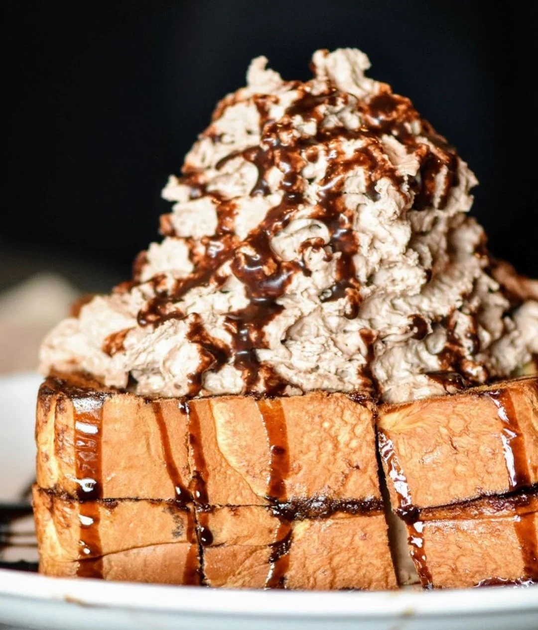 Nutella chocolate bread topped with cream and chocolate