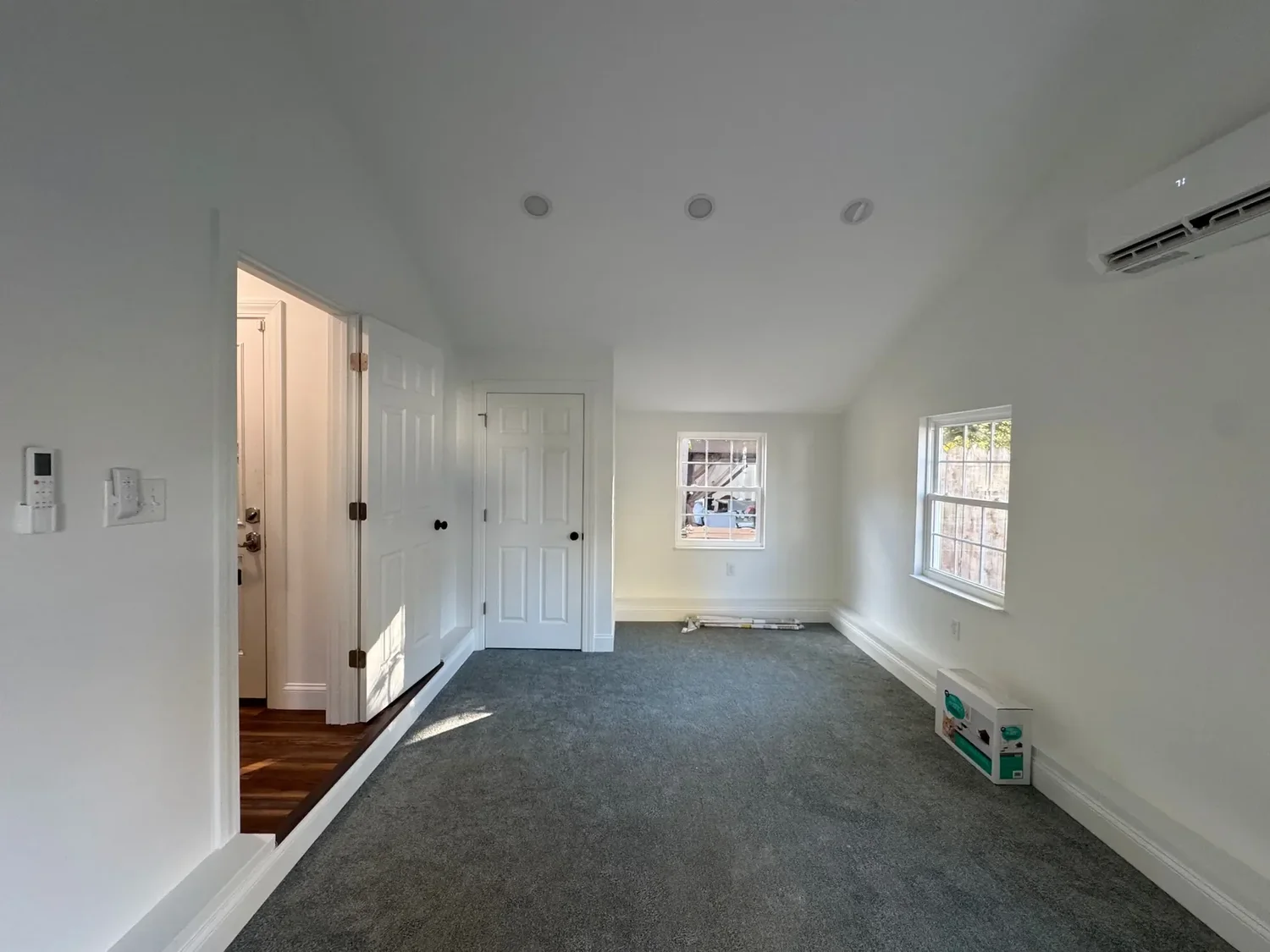 Finished bedroom created from the detached garage, with vaulted ceiling, carpet and windows