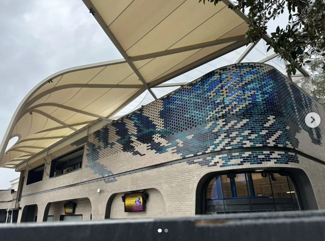 The same building completed, with blue glazed feature bricks and arches