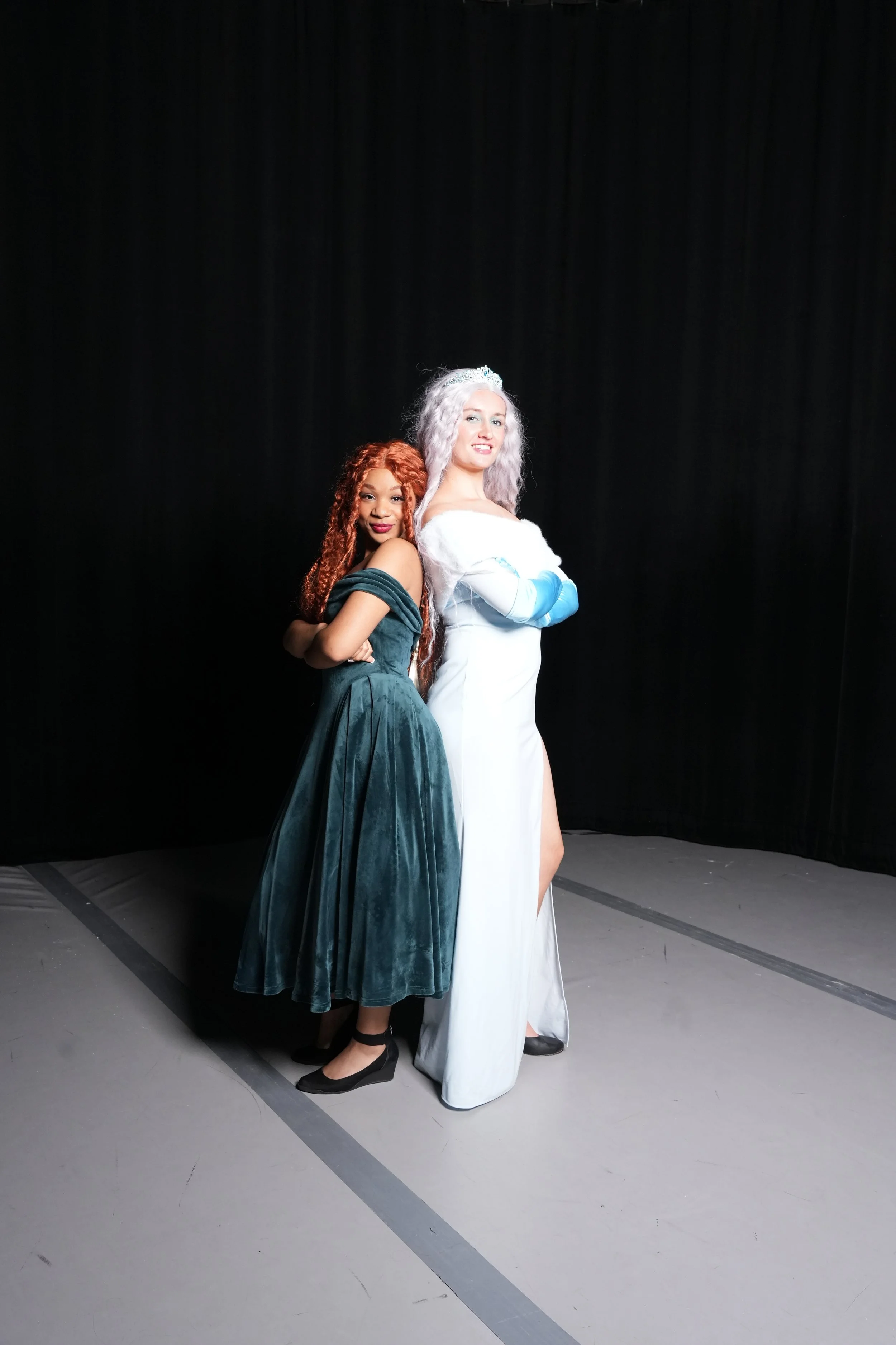 Two ActUp Theater Frozen Jr. performers posing back-to-back in costume.