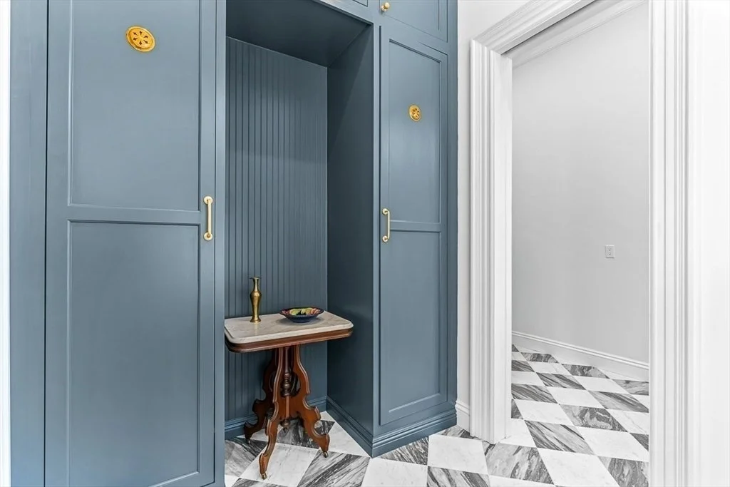 Artisans blue custom cabinetry with brass hardware