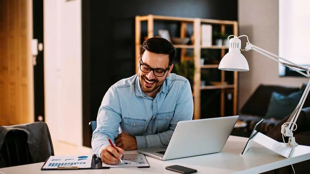 Self-employed professional reviewing paperwork at a desk