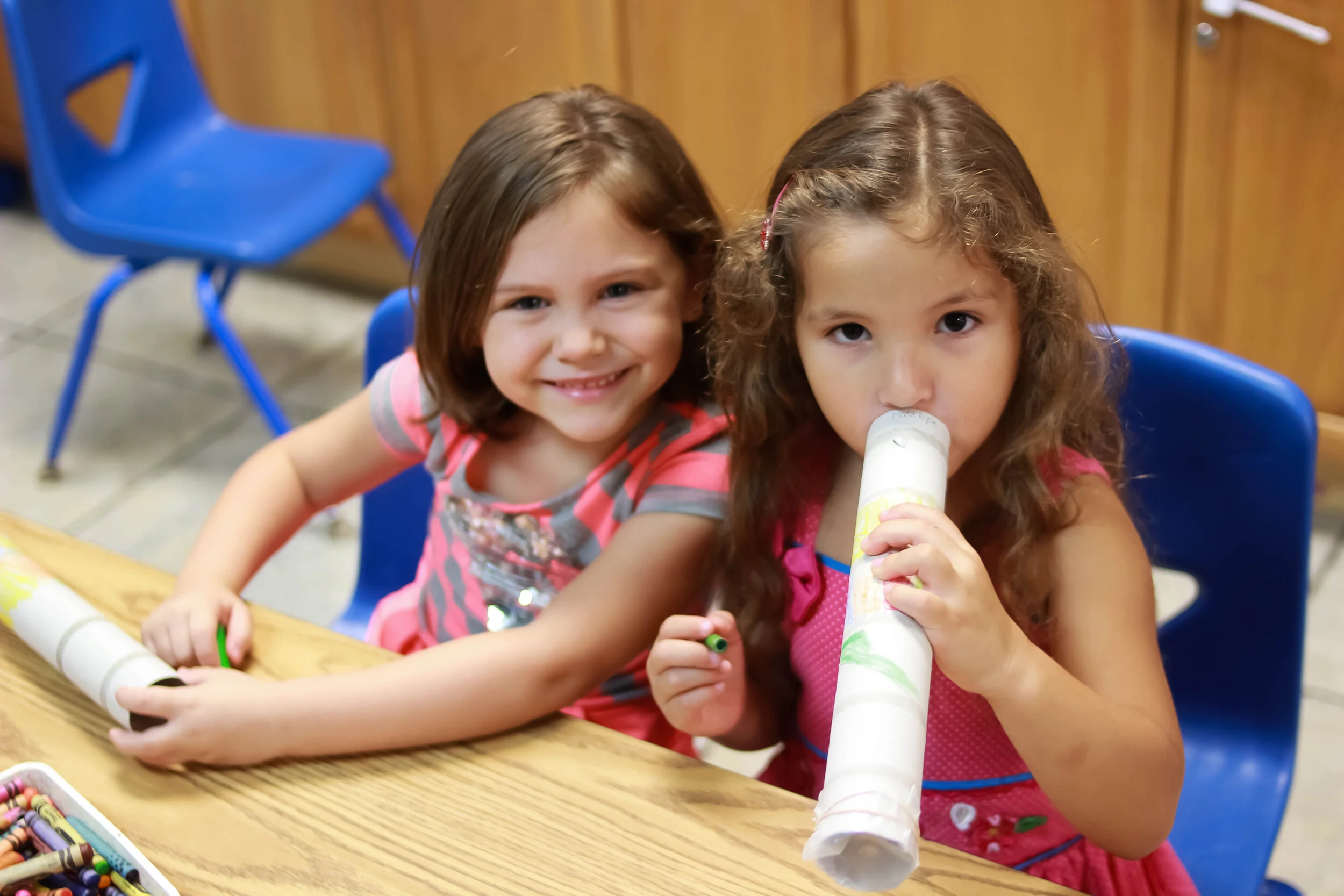 Two young children learning and playing at an activity table at Christ Fellowship Tampa