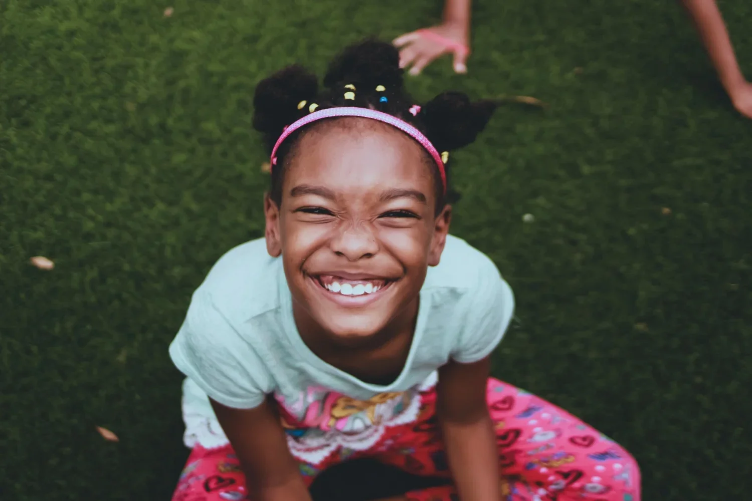 A smiling elementary-age child enjoying a welcoming children’s ministry environment