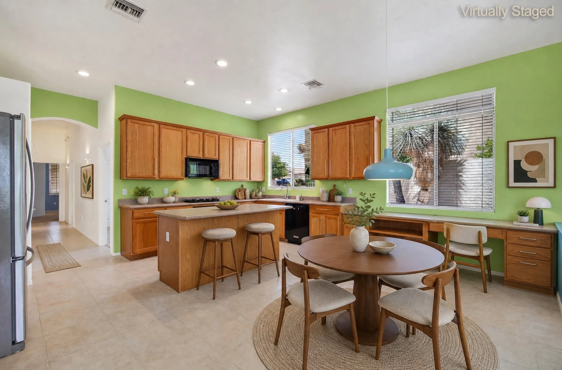 Virtually staged kitchen at 11546 N Mountain Breeze Drive with wood cabinetry, center island and breakfast nook