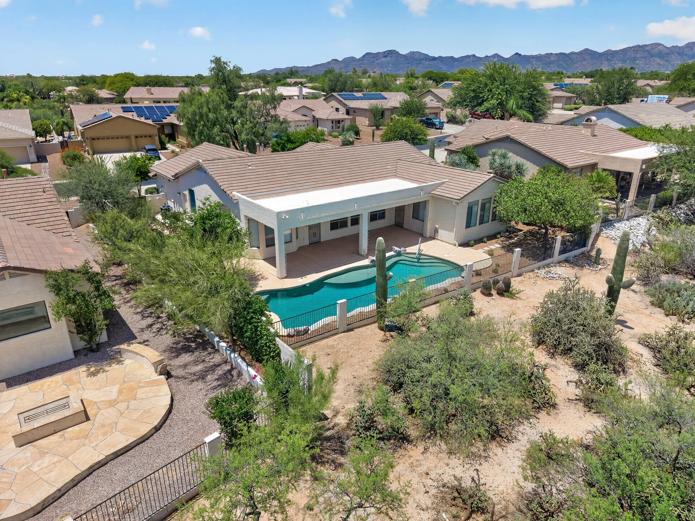 Aerial view of the Mountain Breeze backyard, pool and the desert common area behind the lot