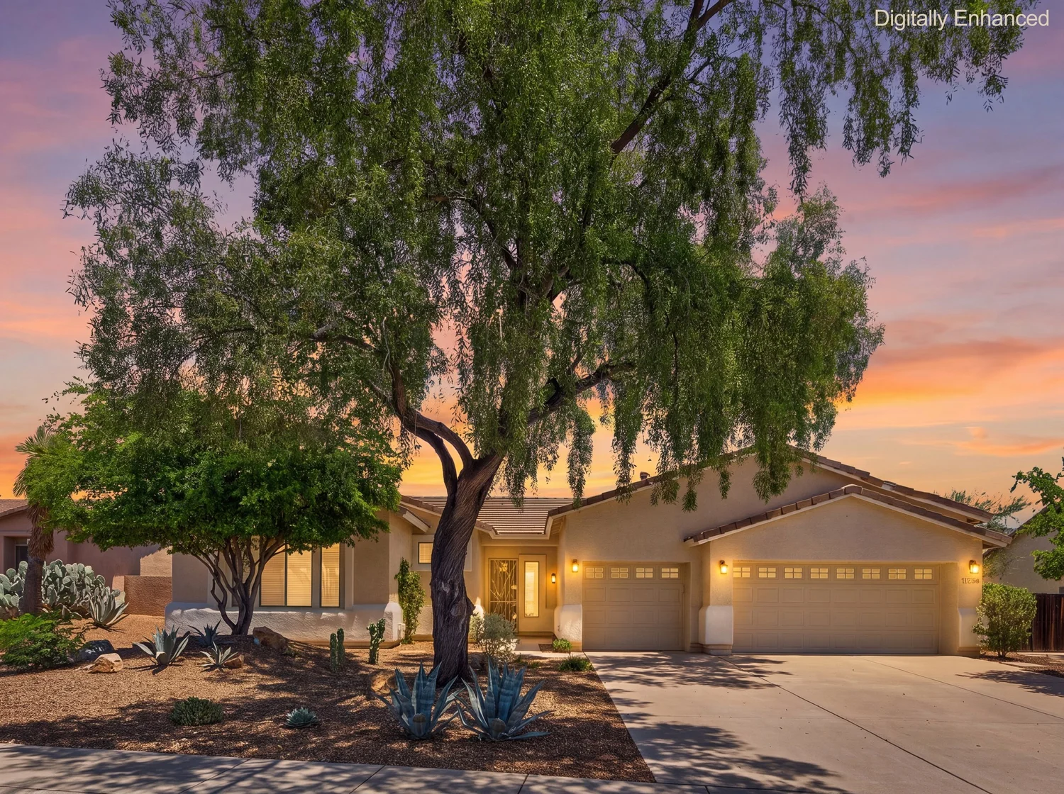 11546 N Mountain Breeze Drive in Oro Valley at twilight, with a desert willow over the courtyard entry