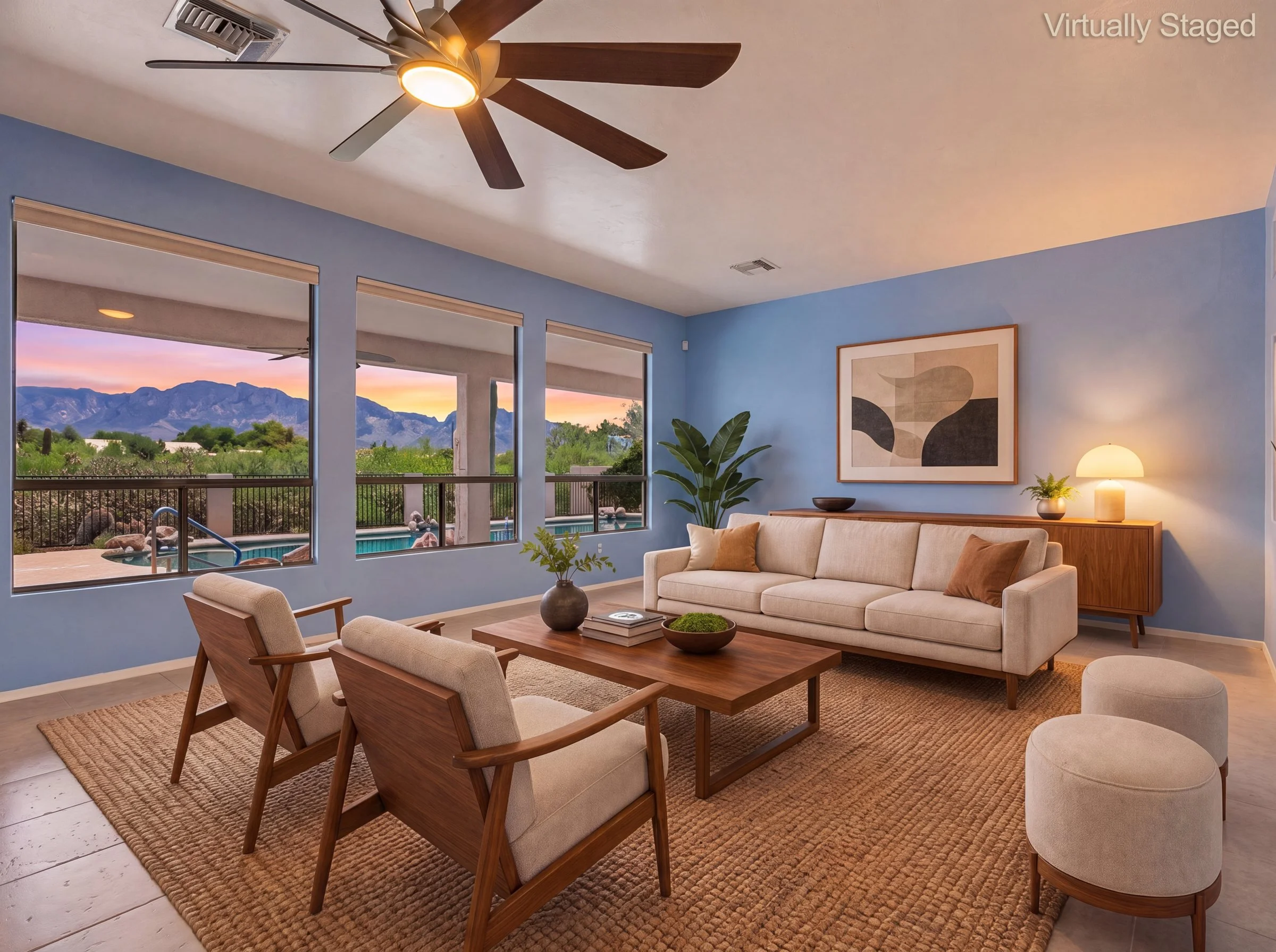 Virtually staged living room with picture windows facing the Catalina Mountains at sunset