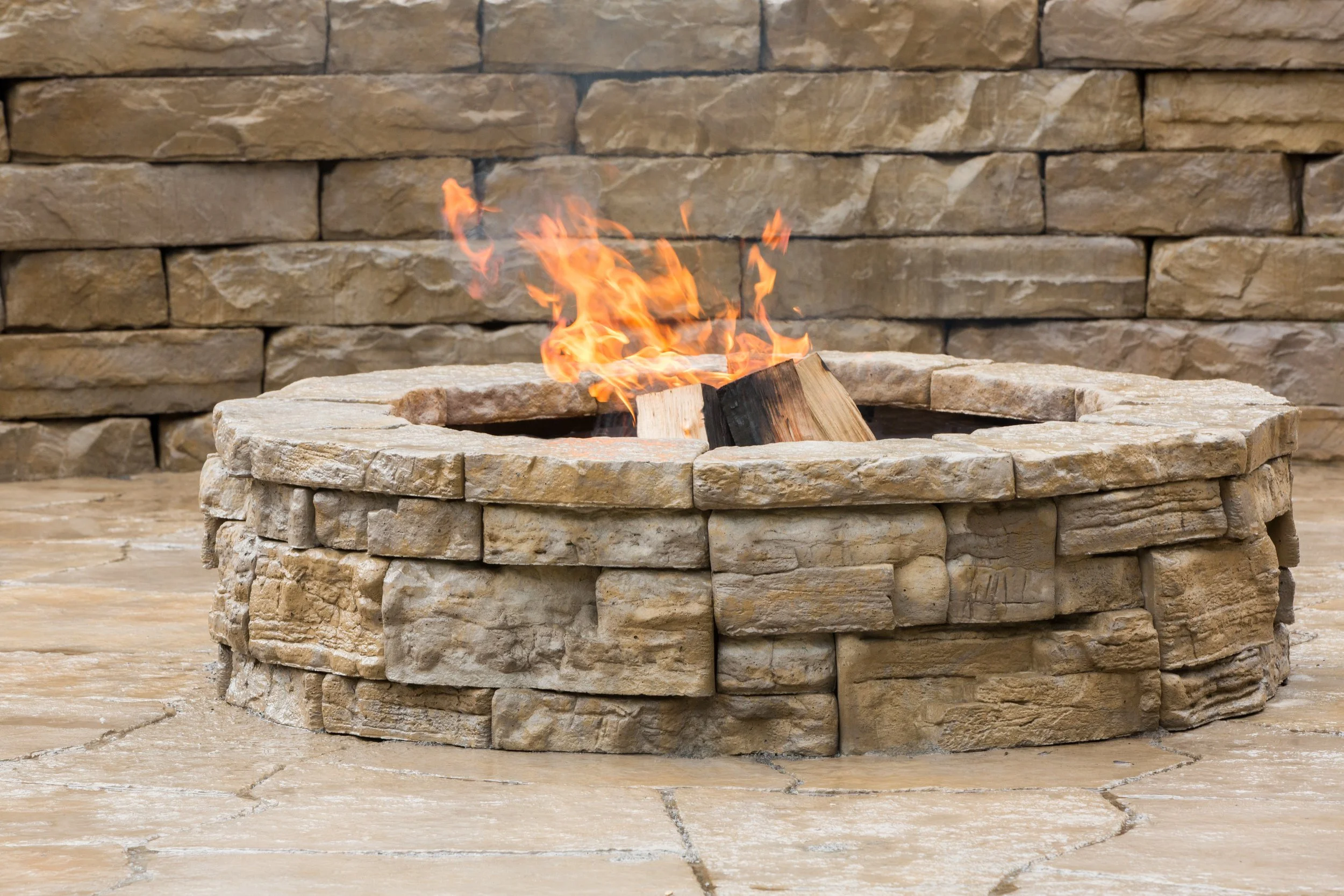 Outdoor fire feature and seating wall using Kodah wet-cast concrete blocks