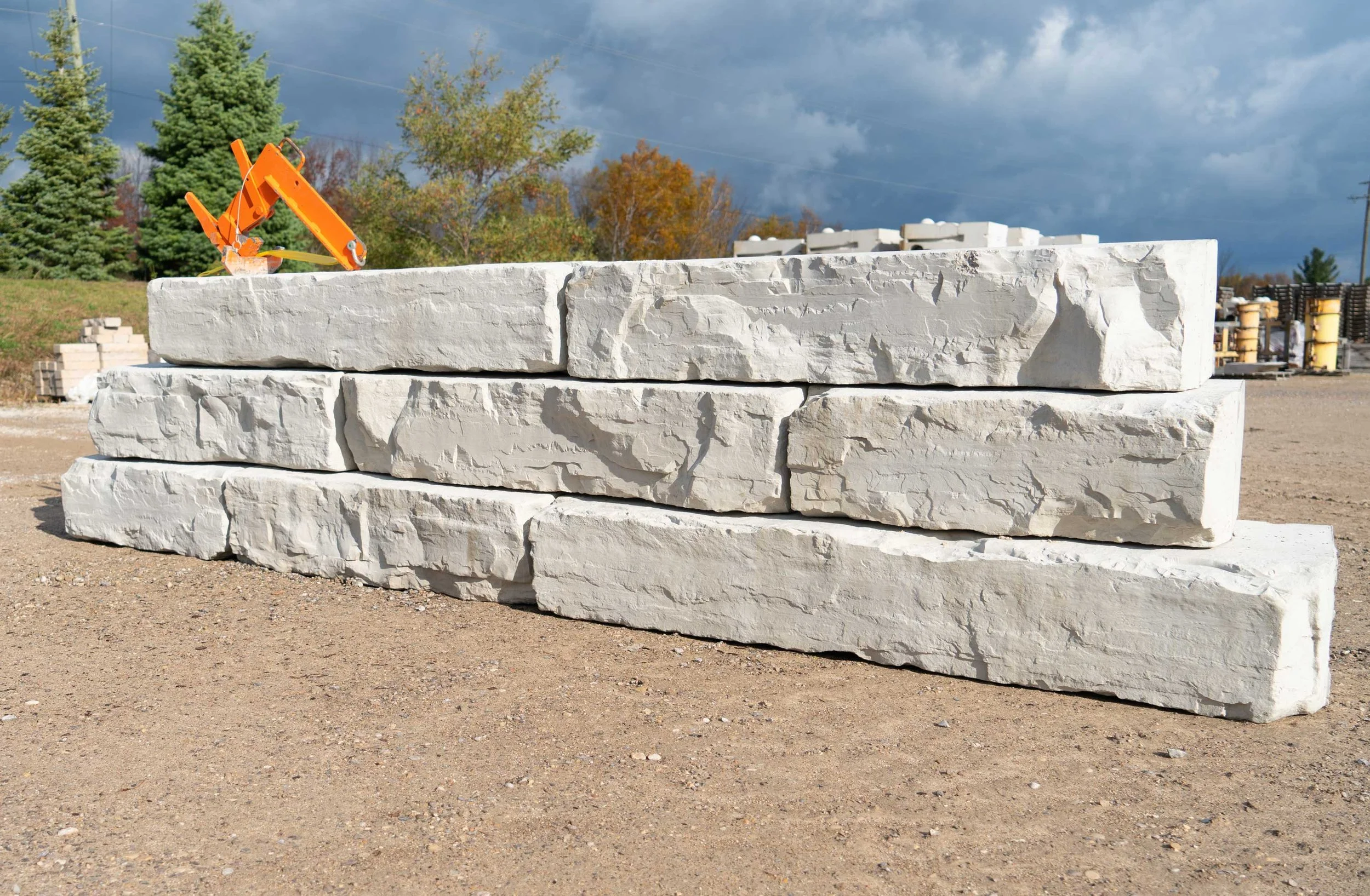 Grand Ledge blocks staged on a commercial job site, showing the large-scale format and block mass