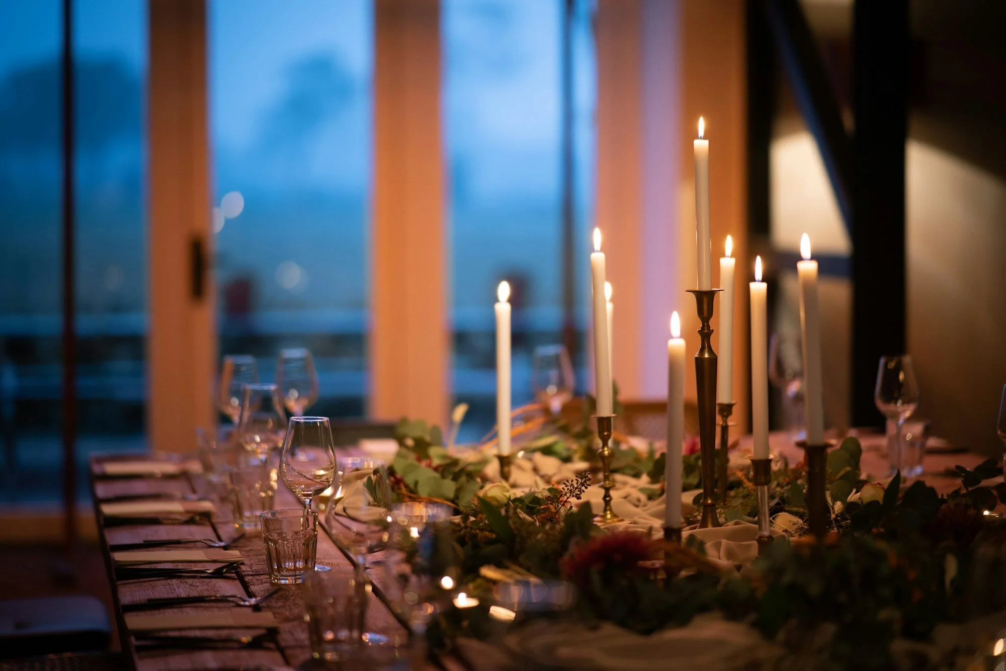 A candlelit dinner table at dusk