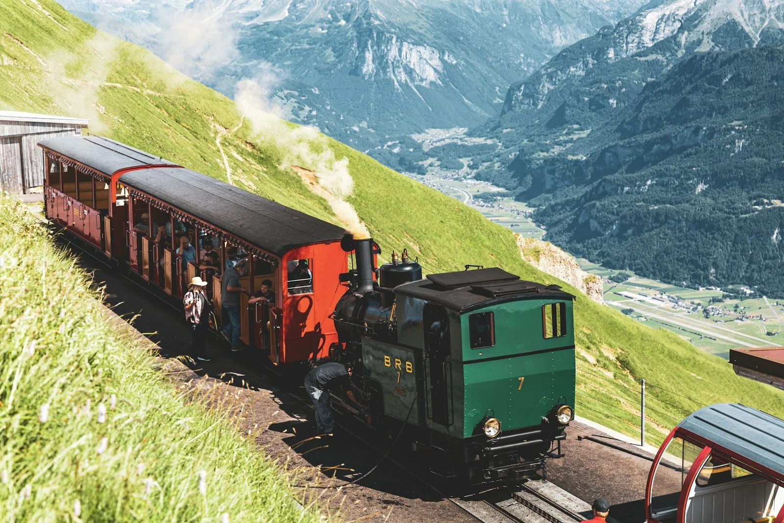 A vintage train climbing through the Swiss Alps