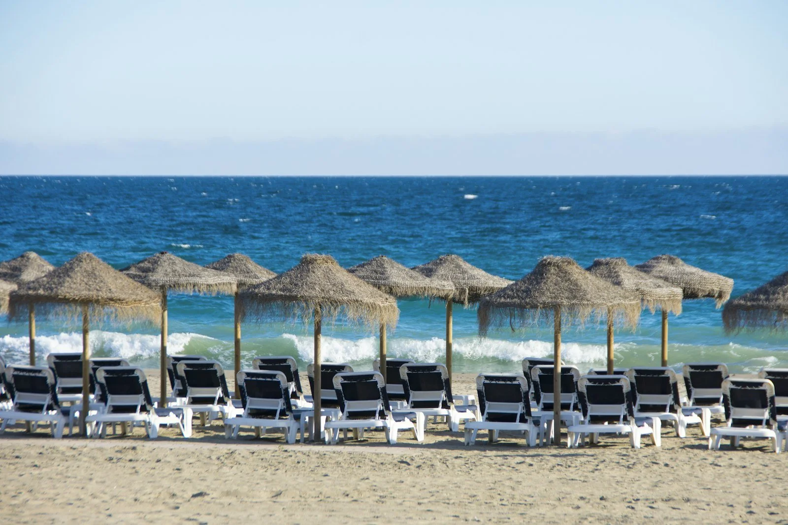 Palapa umbrellas on a Costa del Sol beach
