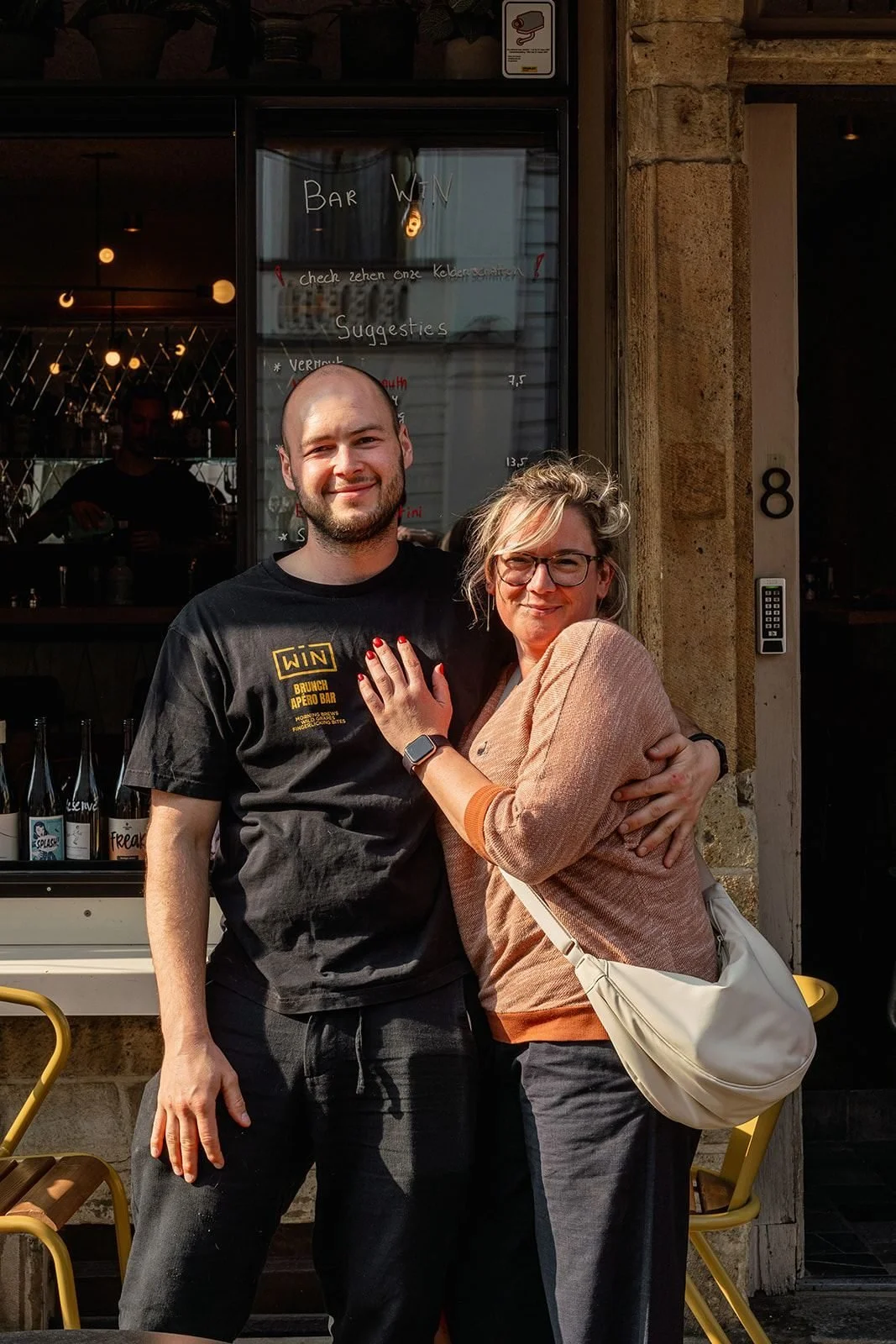 At the door of wine bar Win on Burgstraat in Ghent